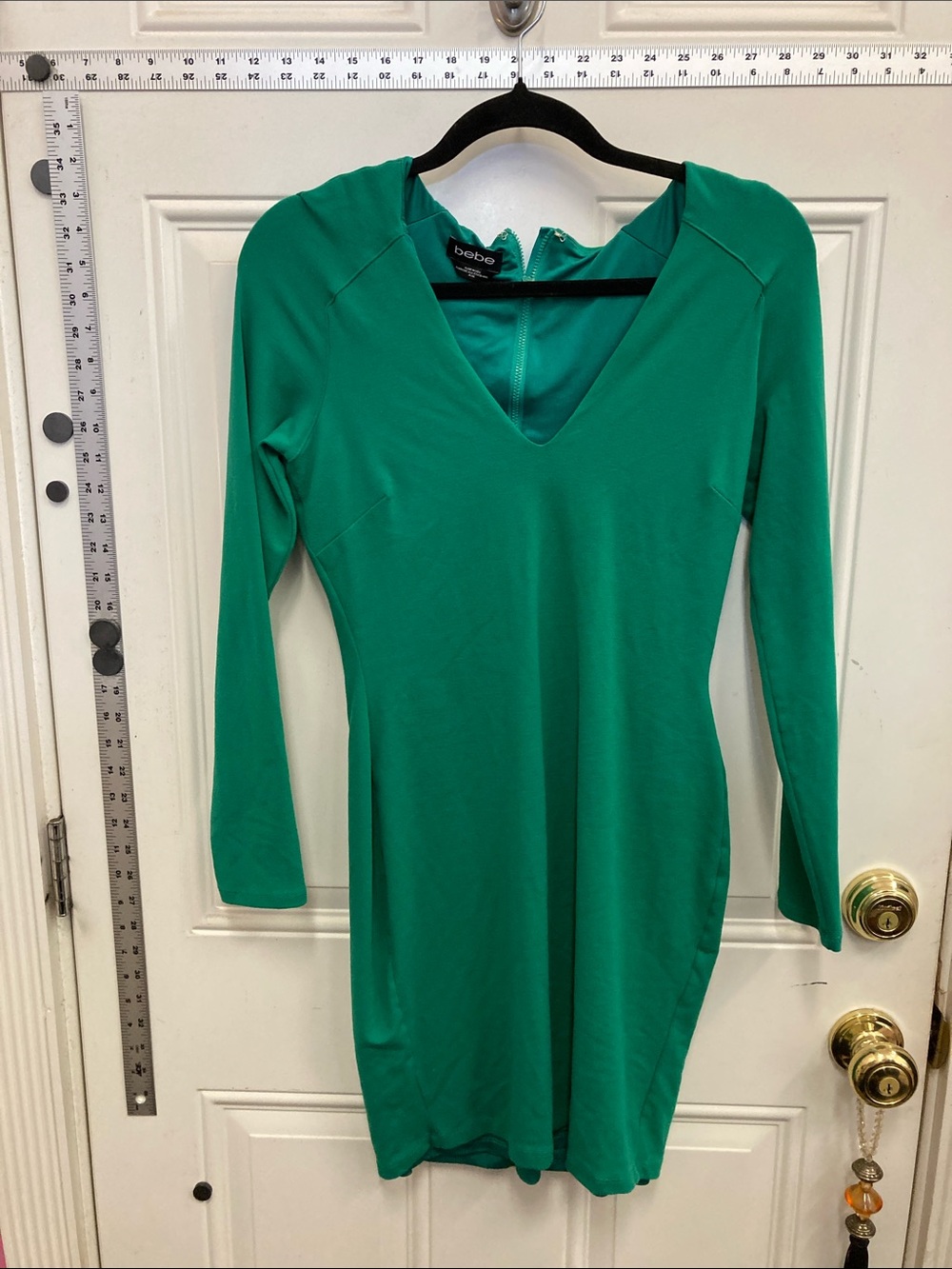 Green, Form-fitting, V-neck, sleek silhouette, Smooth, stretchy fabric.